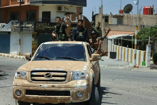 مسلحون من الدروز خلال دورية في السويداء (أ.ف.ب)