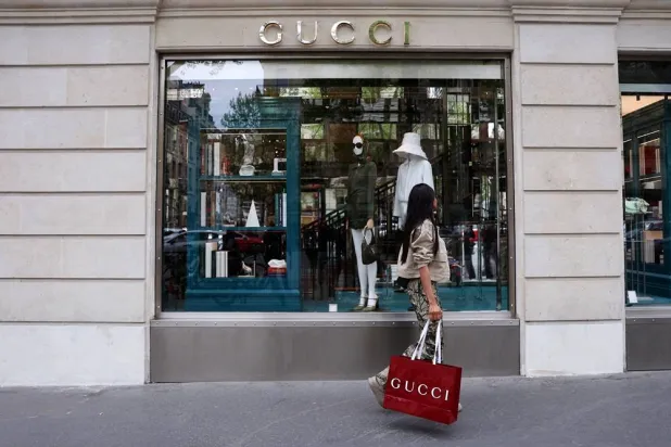 A woman walks past a shop of fashion house Gucci in Paris, France, April 17, 2025. (Reuters) 
