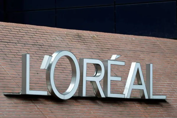 The logo of French cosmetics Groupe L'Oreal is seen on the L'Oreal group's headquarters building in Clichy, near Paris, France, April 14, 2025. (Reuters) 
