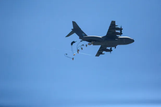 طائرة نقل تلقي رزم مساعدات إنسانية فوق غزة الجمعة (أ.ف.ب)