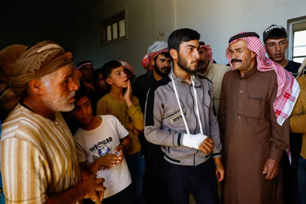 مجموعة من العائلات البدوية التي غادرت السويداء في مدرسة تُستخدم مركز إيواء بقرية السهوة بمحافظة درعا (رويترز)
