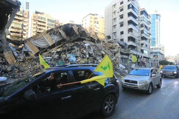 Motorists wave Hezbollah flags as they parade in Beirut's southern suburbs on Nov. 27, 2024. (AFP/Getty Images)