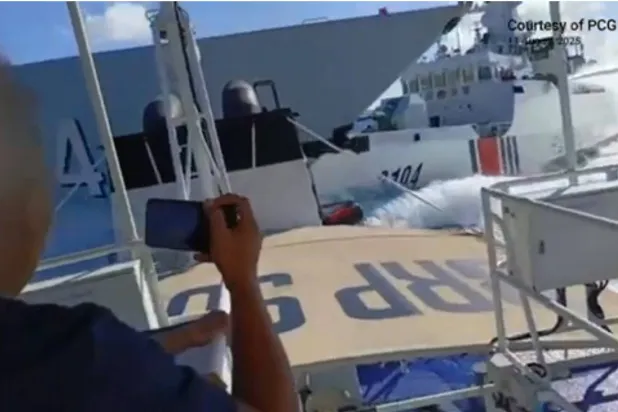 صورة من فيديو نشره خفر السواحل الفلبيني بعد وقوع حادث بين سفينة تابعة للبحرية الصينية (يساراً) وسفينة تابعة لخفر السواحل الصيني (يميناً) كما شوهد من قارب صيد فلبيني بالقرب من جزر سكاربورو في بحر الصين الجنوبي (أ.ف.ب)