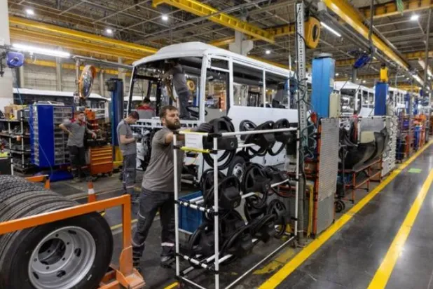 فنيون يعملون على حافلة في خط إنتاج مصنع «أوتوكار» التركي في بلدة أريفييه بمحافظة سكاريا (رويترز)