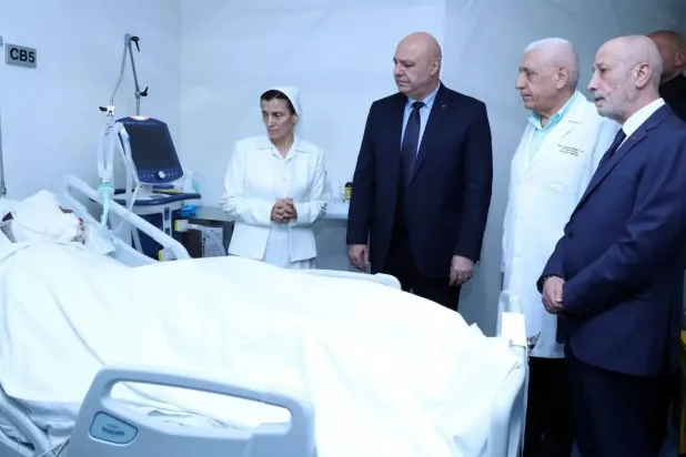 President Joseph Aoun visits a soldier in hospital where he is receiving treatment to injuries sustained during the dismantling munitions in an arms depot on Saturday. (Lebanese Presidency) 