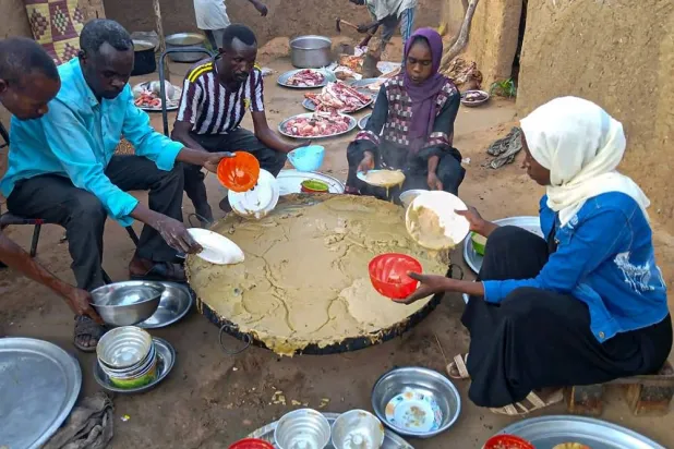 Sudanese residents gather to receive free meals in El-Fasher, a city besieged by Sudan's paramilitary Rapid Support Forces (RSF) for more than a year, in Darfur region, on August 11, 2025. (AFP)