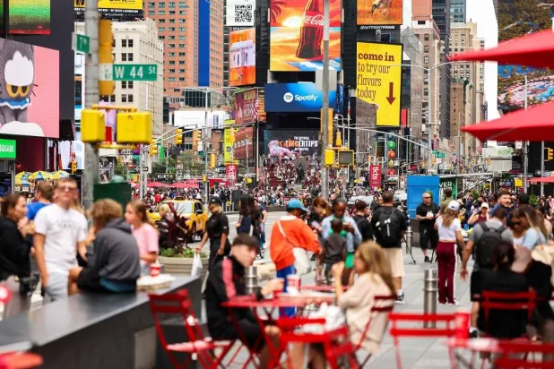 Pedestrians and vehicles move through Times Square in the Manhattan borough of New York City on August 18, 2025. (AFP)