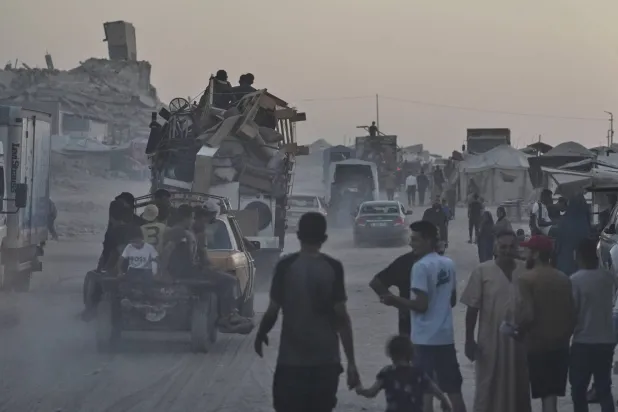 فلسطينيون ينقلون أغراضهم على سيارات ضمن موجة نزوح جديدة من مدينة غزة - 23 أغسطس 2025 (أ.ب) 