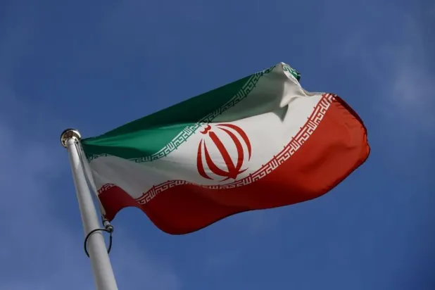 The Iranian flag waves in front of the International Atomic Energy Agency (IAEA) headquarters, before the beginning of a board of governors meeting, amid the coronavirus disease (COVID-19) outbreak in Vienna, Austria, March 1, 2021. (Reuters)
