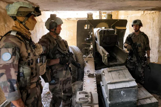 عناصر من «يونيفيل» يضبطون مدفعاً آلياً لـ«حزب الله» في بلدة الماري الحدودية بجنوب لبنان (أ.ف.ب)