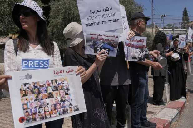Palestinian and Israeli activists and journalists take part in a protest against the killing of Palestinian journalists in the Gaza Strip, as they gather in Nazareth, Israel, Friday, Aug. 29, 2025. (AP Photo/Mahmoud Illean)
