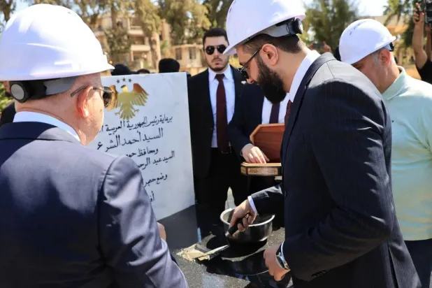 President Ahmed al-Sharaa lays the foundation stone for the Dar al-Salam project in Homs. (Syrian Presidency). 