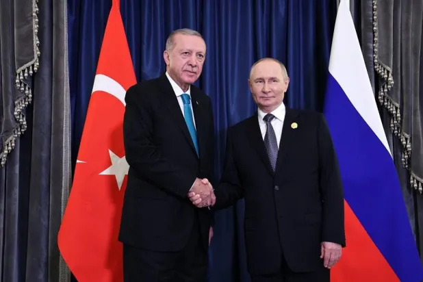 01 September 2025, China, Tianjin: Russian President Vladimir Putin (R) shakes hands with Turkish President Recep Tayyip Erdogan ahead of a joint meeting on the sidelines of the 25th Heads of State Council meeting of the Shanghai Cooperation Organization (SCO). (Kremlin/dpa) 