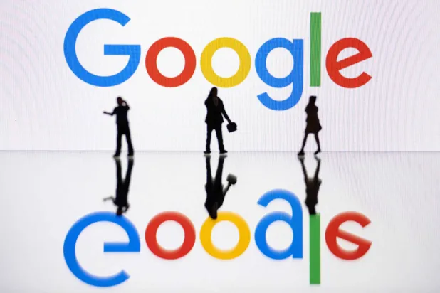 (FILES) This illustration photograph taken on October 30, 2023, in Mulhouse, eastern France, shows figurines next to a screen displaying a logo of Google, a US multinational technology company. (Photo by SEBASTIEN BOZON / AFP)