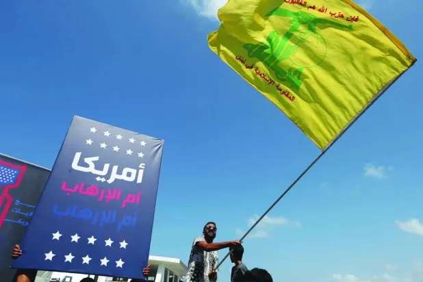 Hezbollah supporters wave flag in protest against US envoy’s south Lebanon visit (AP)  