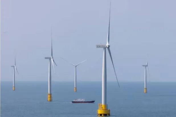 سفينة تبحر بين توربينات الرياح في مضيق تايوان قبالة ساحل جزيرة بينغتان مقاطعة فوجيان الصين (أرشيفية - رويترز)