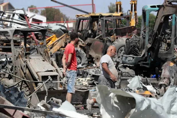 Lebanese people inspect a site targeted by an Israeli airstrike in the town of Ansarya in southern Lebanon last Thursday (dpa) 