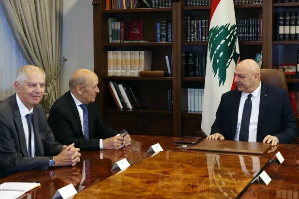 This handout photo released by the Lebanese Presidency press office on September 11, 2025, shows Lebanon's President Joseph Aoun (R) during a meeting with France's envoy to Lebanon Jean-Yves Le Drian (C) at presidential palace in Baabda, east of the capital Beirut. (Lebanese Presidency / AFP)  