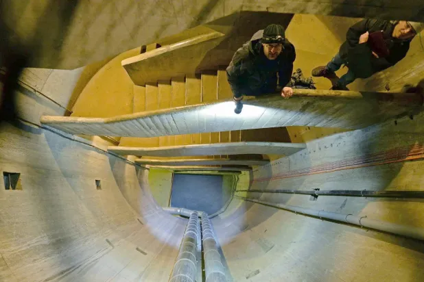 يان سيتشوسكي عالم الحيوان في جامعة زيلونا غورا يقف على درج النفق تحت الأرض (غيتي)