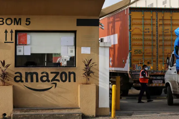 A man inspects trucks before they enter an Amazon storage facility on the outskirts of Mumbai, India, October 1, 2021. Picture taken October 1, 2021. REUTERS/Francis Mascarenhas/File Photo 