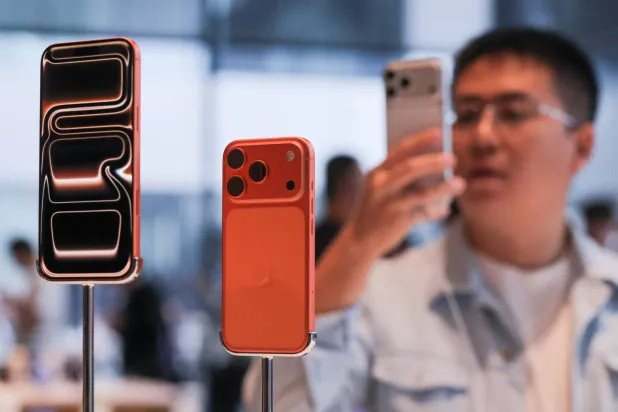 A man takes images of the new iPhone 17 Pro smartphones as they are displayed at the Apple store in Beijing's Sanlitun area during the start of sales in Beijing, China September 19, 2025. REUTERS/Maxim Shemetov