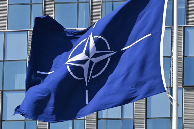 FILED - 03 April 2025, Belgium, Brussels: A NATO flag flies in the wind in front of the NATO headquarters in Brussels. Photo: Anna Ross/dpa