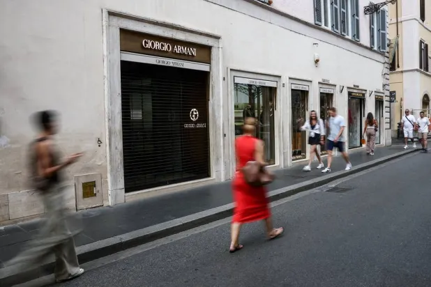 People walk past a closed Giorgio Armani store as it closes for mourning on the day of the Italian fashion designer’s funeral, in Rome, Italy September 8, 2025. (Reuters)
