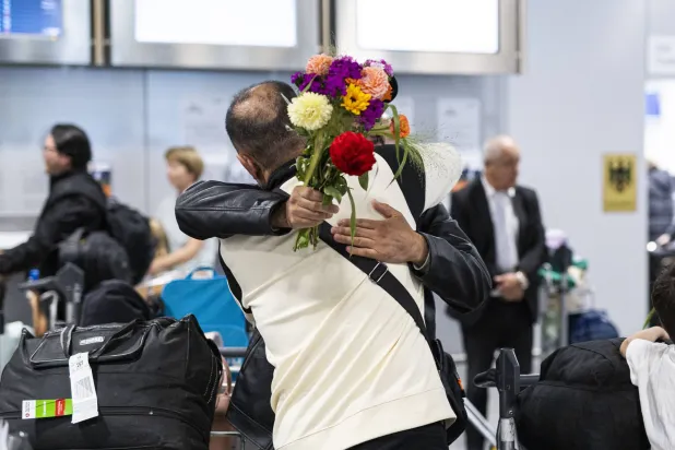 استقبالٌ للقادمين من أفغانستان بعد وصولهم إلى مطار هانوفر - لانغنهاغن... بعد أشهرٍ من الانتظار وصلت عدة عائلات إلى ألمانيا بوعدٍ بقبولهم (د.ب.أ)