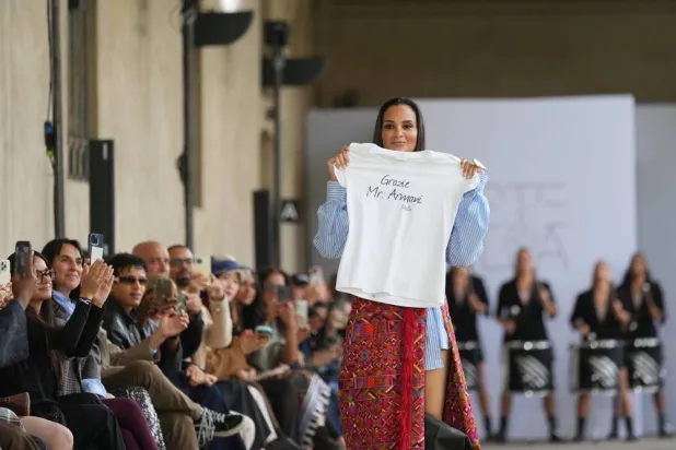  Fashion designer Stella Jean walks the runway with a tribute to late Italian fashion legend Giorgio Armani who died in Milan on Sept. 4, at the end of her Spring/Summer 2026 collection during Milan Fashion Week in Milan, Italy, Saturday, Sept. 27, 2025. (AP) 