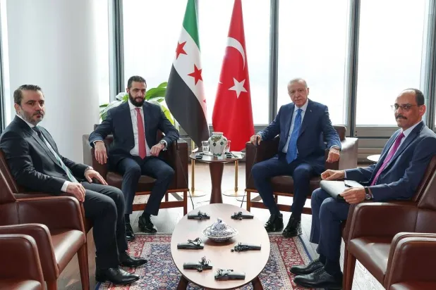 This handout photograph taken and released by Turkish Presidency Press Office on September 24, 2025, shows Türkiye’s President Recep Tayyip Erdogan (2nd R), Syria's interim President Ahmed al-Sharaa (2nd L), Turkish National Intelligence Organization (MIT) Director Ibrahim Kalin (R) and Syrian Foreign Minister Asaad al-Shaibani (L) attending a meeting as part of his visit to the United States for the 80th United Nations General Assembly in New York. (Handout / Turkish Presidency Press Office / AFP)  