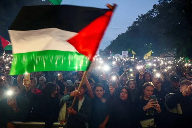 Demonstrators light mobile phones flashlights during the "All eyes on Gaza" rally in Berlin, Germany, September 27, 2025. (Reuters)