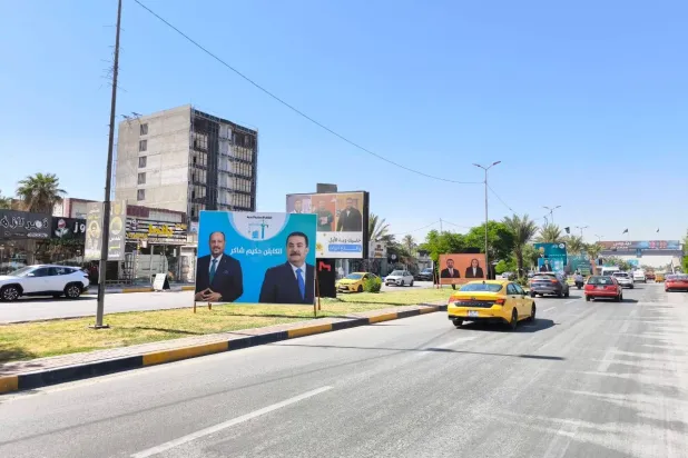 صور مرشحين في «شارع فلسطين» ببغداد (الشرق الأوسط)