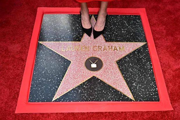 US actress Lauren Graham (detail shoes) stands on her newly unveiled star on the Hollywood Walk of Fame during a ceremony in Hollywood, California, on October 3, 2025. (Photo by Frederic J. BROWN / AFP)