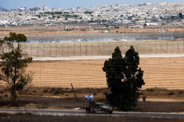An Israeli military vehicle maneuver, after US President Donald Trump announced that Israel and Hamas agreed on the first phase of a Gaza ceasefire, on the Israeli side of the border with Gaza, October 9, 2025. REUTERS/Ammar Awad