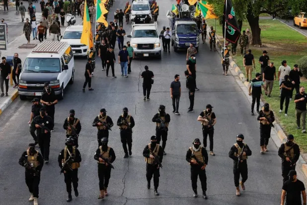 Kataib Hezbollah fighters during a parade in Baghdad, September 2024 (File/Reuters)