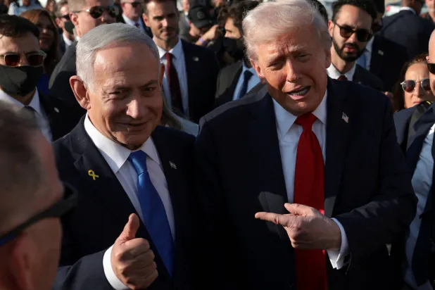 US President Donald Trump gestures next to Israeli Prime Minister Benjamin Netanyahu at Ben Gurion International Airport as Trump leaves Israel en route to Sharm el-Sheikh, Egypt, to attend a world leaders' summit on ending the Gaza war, amid a US-brokered prisoner-hostage swap and ceasefire deal between Israel and Hamas, in Lod, Israel, October 13, 2025. (Reuters)