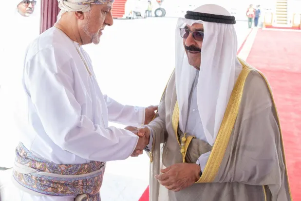 السلطان هيثم بن طارق لدى استقباله الشيخ مشعل الأحمد أمير الكويت عقب وصوله إلى السلطنة اليوم (كونا)