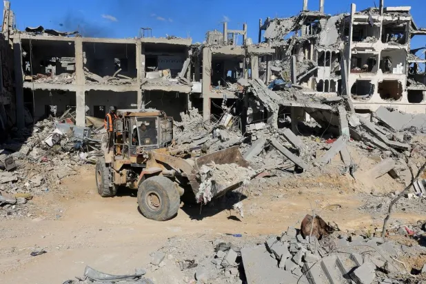 Heavy machinery removes debris from a street, amid a ceasefire between Israel and Hamas, in Gaza City, October 14, 2025. (Reuters)