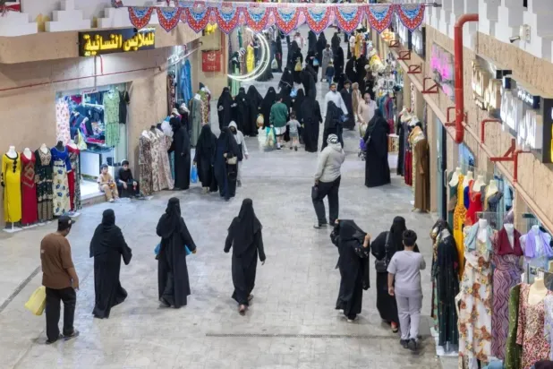 أشخاص يتسوقون بإحدى أسواق الرياض (أ.ف.ب)