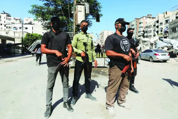 Hamas police officers patrol a street in Gaza City (Reuters)

