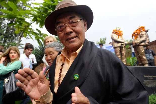 (FILES) Kancha Sherpa gestures after offering garlands over the statues of Tenzing Norgay and Edmund Hillary during the Mount Everest Diamond Jubilee celebrations in Kathmandu on May 29, 2013. (Photo by Prakash MATHEMA / AFP)