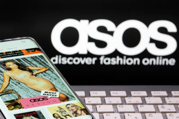 FILE PHOTO: Smartphone with an ASOS app and a keyboard are seen in front of a displayed ASOS logo in this illustration picture taken October 13, 2020. REUTERS/Dado Ruvic/Illustration/File Photo