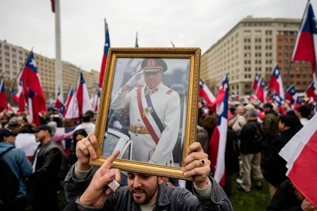 A group in favor of Gen. Augusto Pinochet celebrate the 50th anniversary of a military coup led by Pinochet, near La Moneda presidential palace, in Santiago, Chile, Sept. 9, 2023. (AP) 