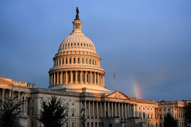 A rainbow is visible in the clouds behind the Capitol Building, weeks into the continuing US government shutdown on Capitol Hill in Washington, D.C., US, October 18, 2025. REUTERS/Aaron Schwartz