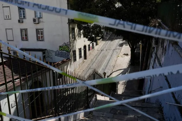 Police tape cordons-off the access to the tracks of the Gloria funicular, a tourist streetcar that derailed and crashed, in Lisbon, Sept. 5, 2025. (AP)