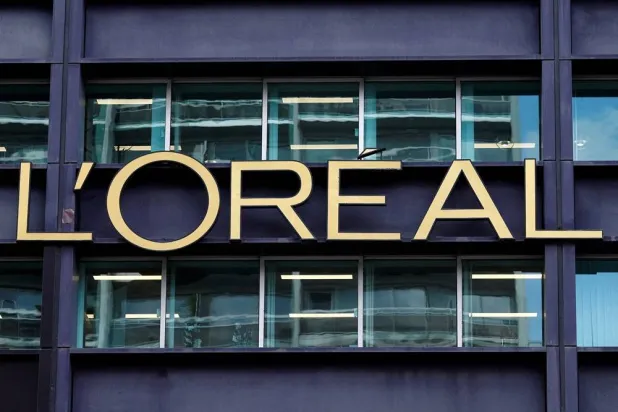 The logo of French cosmetics Groupe L'Oreal is seen on the L'Oreal group's headquarters building in Clichy, near Paris, France, April 14, 2025. (Reuters) 
