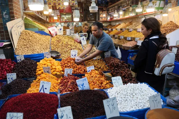 Iranian women shop in a store at the Tehran Bazaar after the approval of the bill to remove four zeros from the national currency, in Tehran, Iran, October 5, 2025. Majid Asgaripour/WANA (West Asia News Agency) via Reuters