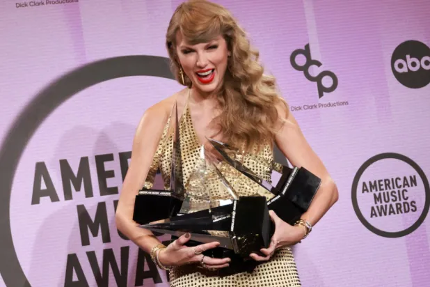 Taylor Swift poses with the Artist of the Year, Favourite Music Video, Favourite Female Pop Artist, Favourite Pop Album, Favourite Female Country Artist, Favourite Country Album award in the press room during the 2022 American Music Awards at the Microsoft Theater in Los Angeles, California, US, November 20, 2022. REUTERS/Aude Guerrucci 