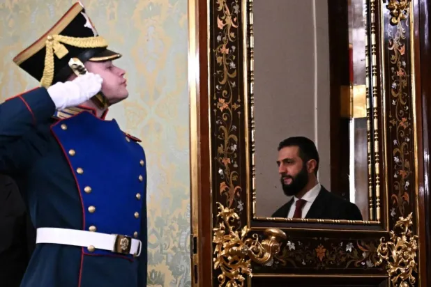 A member of the honor guard salutes Syrian President Ahmed al-Sharaa upon his arrival in Moscow to meet Russian President Vladimir Putin on October 15, 2025 (Reuters)