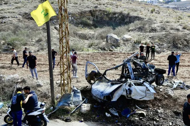 People inspect the wreckage of a vehicle targeted by an Israeli drone in the village of Harouf in the Nabatieh Governorate, southern Lebanon, 25 October 2025. (EPA)